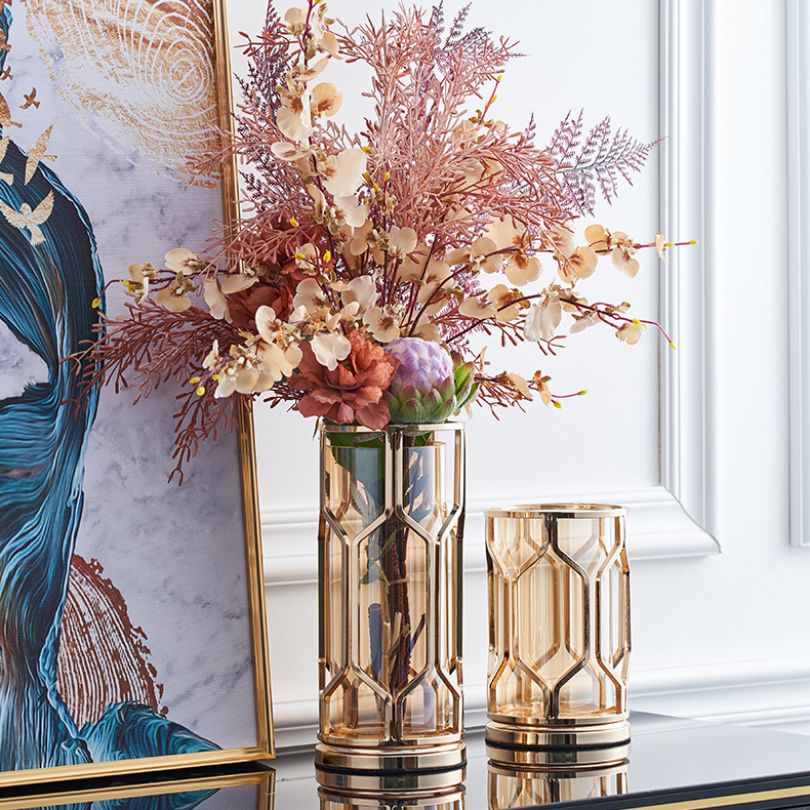 Elegant golden glass vase in a living room setting, enhancing the decor.