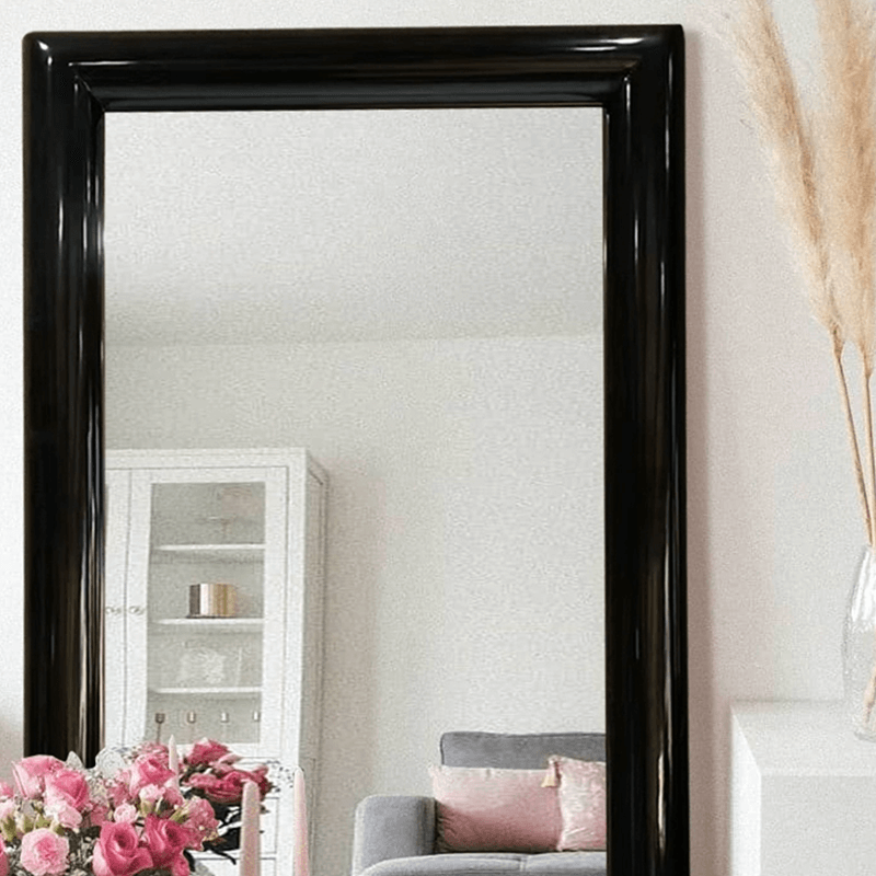 Elegant European style black frame floor mirror leaning against a wall showcasing its sleek design.