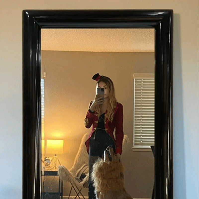 High-quality full-length mirror reflecting natural light in a cozy living room setting.
