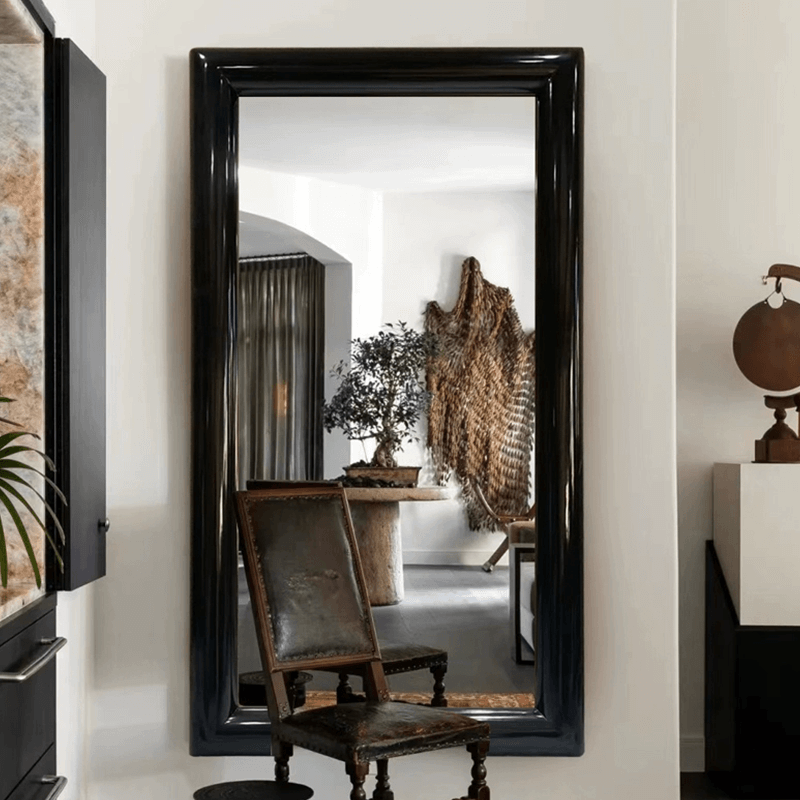 Close-up of the stylish wooden frame of the black frame floor mirror highlighting its craftsmanship.