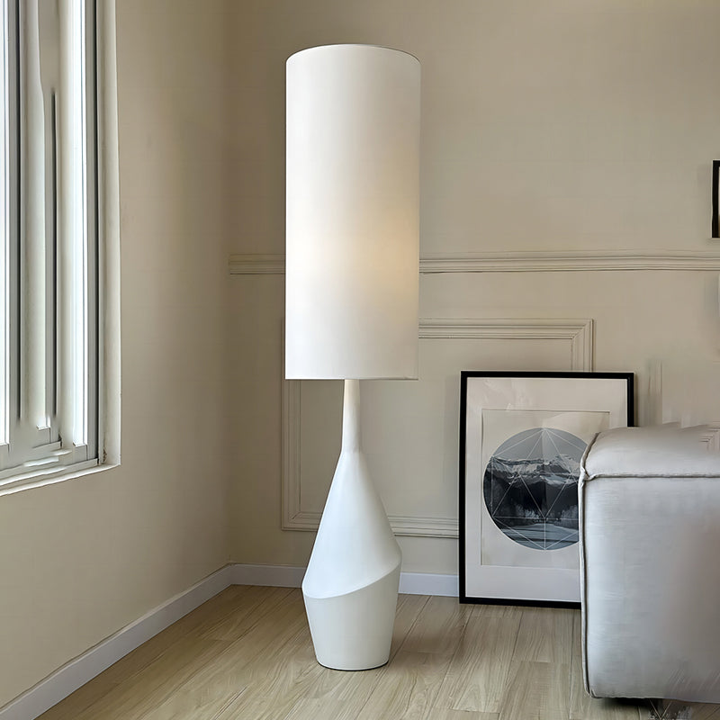 A side view of the Nordic Elegance Cream LED Floor Lamp illuminating a cozy reading nook.