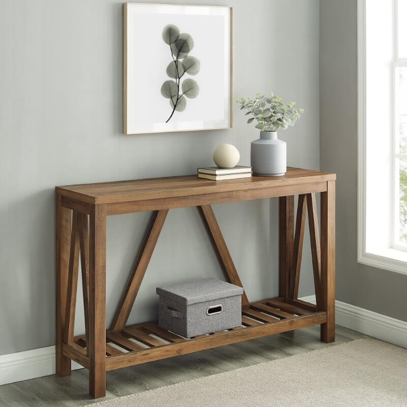 Rustic reclaimed wood console table showcasing open shelf and decorative items.