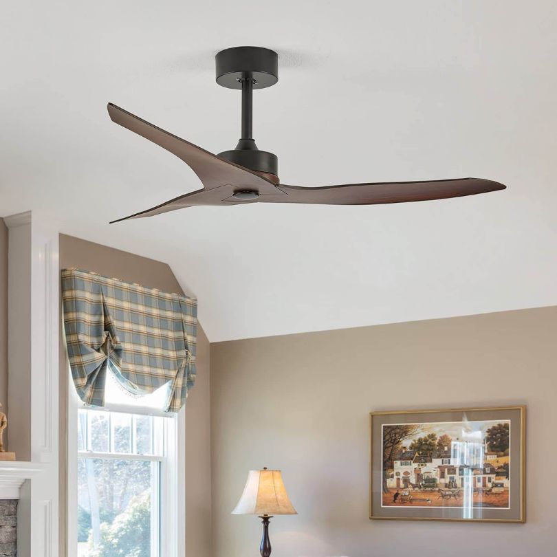 Angled view of reversible ceiling fan mounted in farmhouse-style living room
