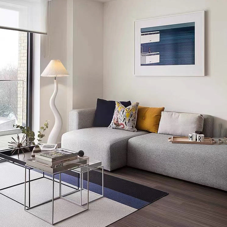 Elegant Curved Mushroom Resin Floor Lamp with warm light in a cozy living room setting.