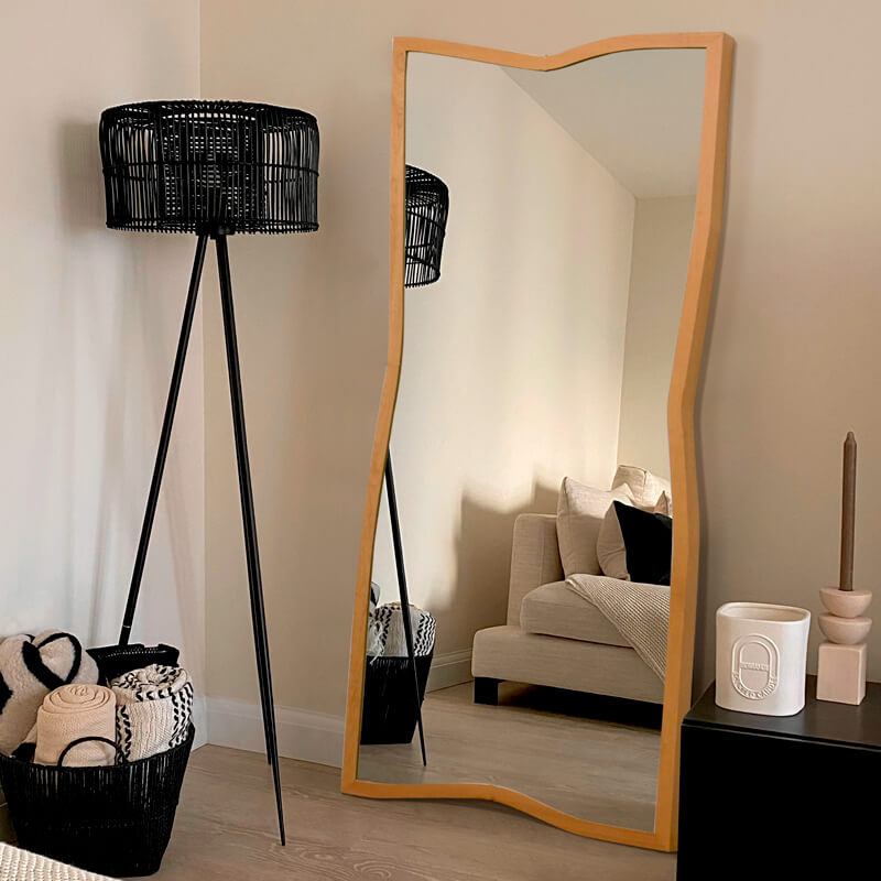 Elegant Nordic wooden frame standing mirror placed in a bright hallway