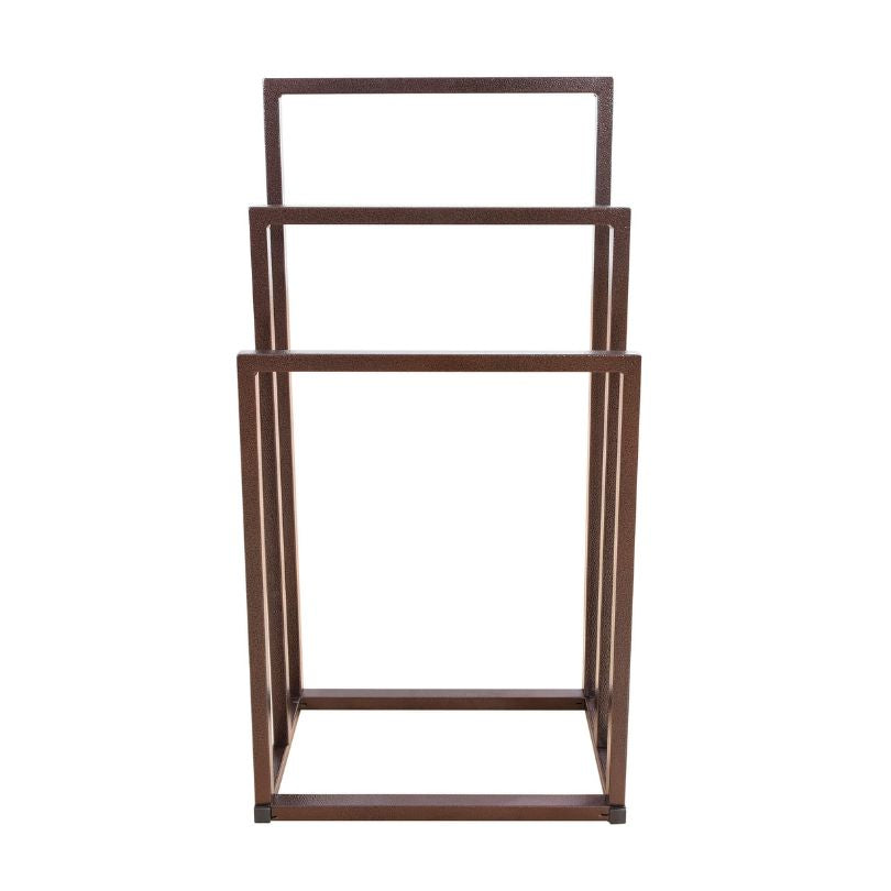 Freestanding towel holder in a modern bathroom setting, holding towels.