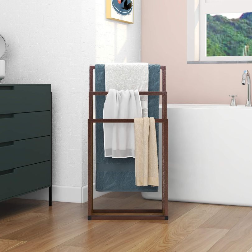Stylish metal towel rack showcasing three tiers with chrome finish.