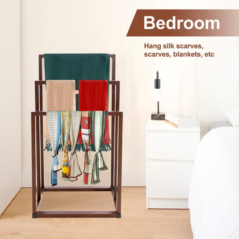 Freestanding towel holder in a modern bathroom setting, holding towels.