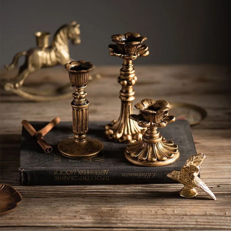 Elegant rustic gold candle holder styled with a scented candle.