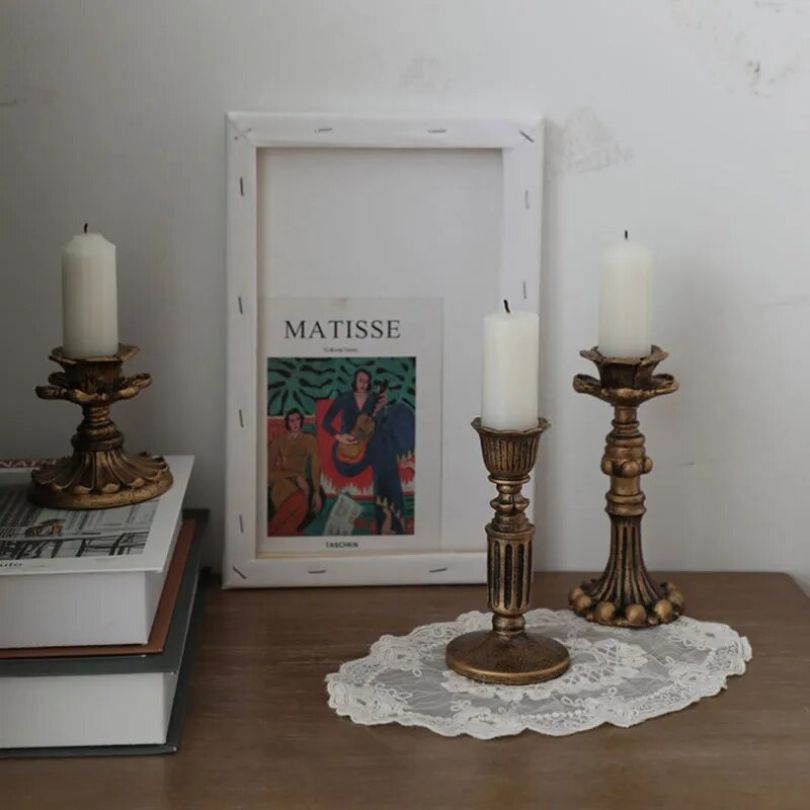 Close-up view of the vintage candle holder showcasing its antique resin finish.