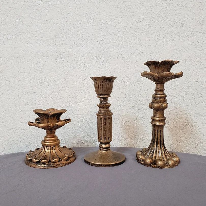 Elegant rustic gold candle holder styled with a scented candle.