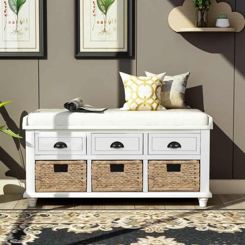 Elegant white storage bench with rattan baskets and drawers, styled in an entryway.