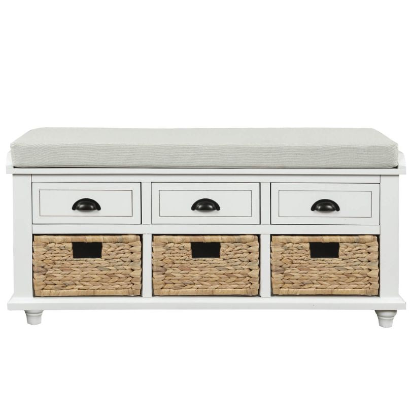 Close-up of the rattan baskets and drawers on the elegant white storage bench.