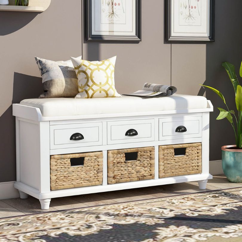 Close-up of the rattan baskets and drawers on the elegant white storage bench.