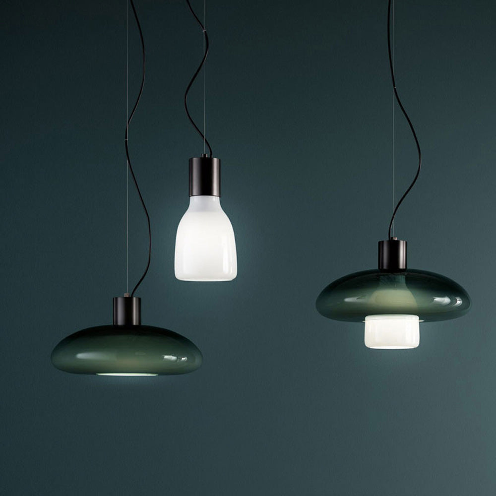 Chic green glass pendant light showcasing its elegant design in a contemporary living room setting.