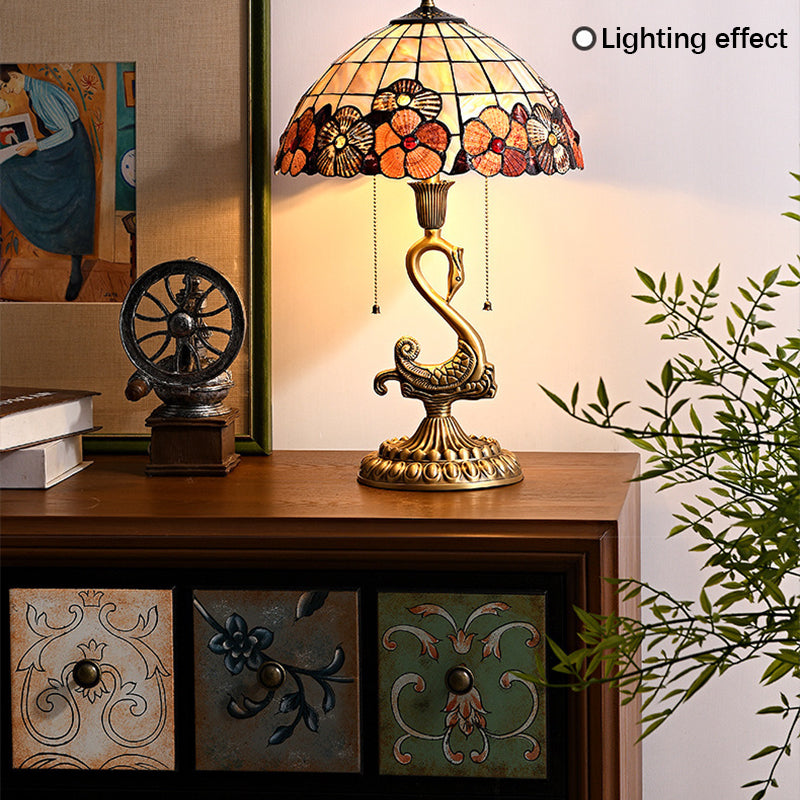 Close-up of the swan brass lamp highlighting the clear glass shade and intricate details.