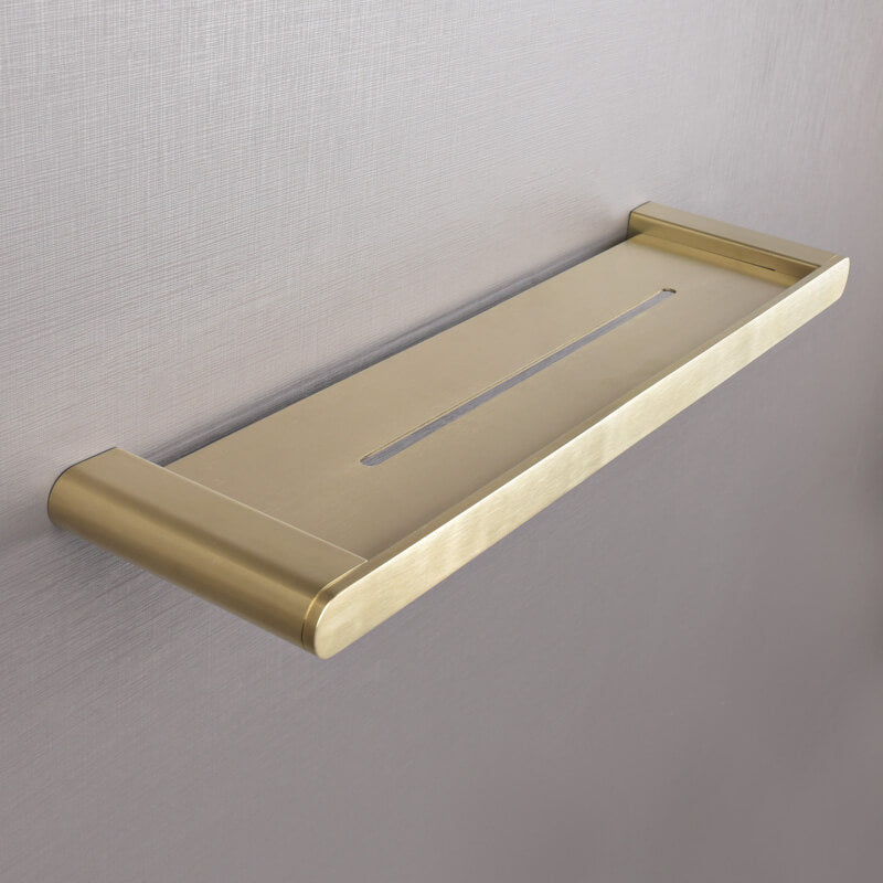 Close-up view of the gold shelf mounted on a wall, highlighting its sleek design and durability.