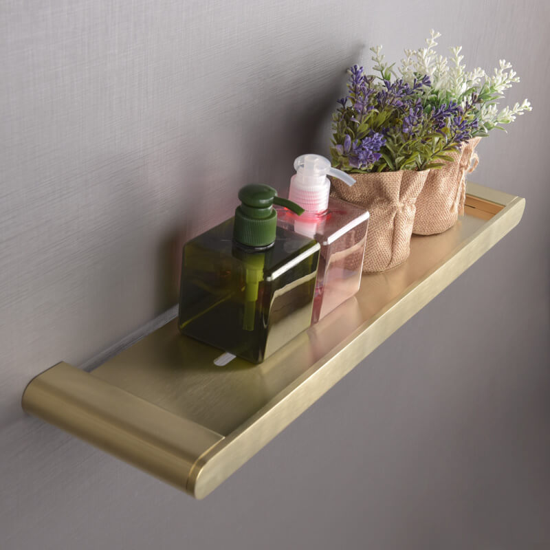 Elegant gold floating shelf showcasing a modern bathroom setup with toiletries displayed.