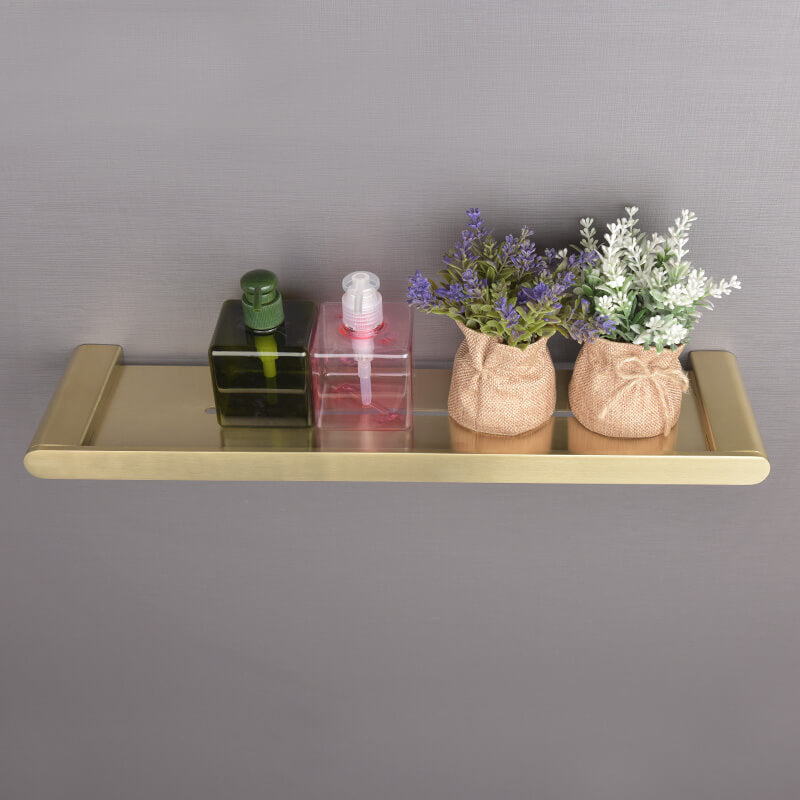 Close-up view of the gold shelf mounted on a wall, highlighting its sleek design and durability.