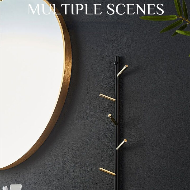 Overall view of the gold and black coat rack installed in a stylish entryway.