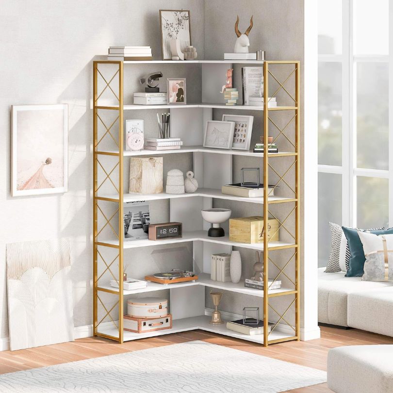 Elegant golden white 7-tier corner metal bookcase showcasing books and decor in a modern living room.