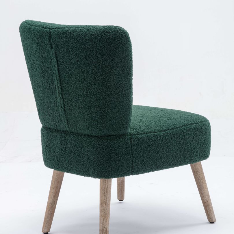 Elegant green teddy fabric accent chair from the side, highlighting tufted buttons and wooden legs.