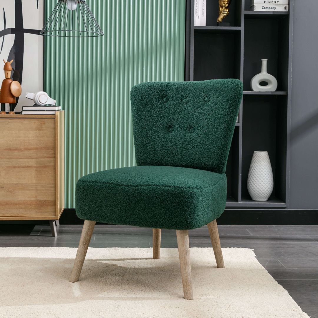 Elegant green teddy fabric accent chair from the side, highlighting tufted buttons and wooden legs.