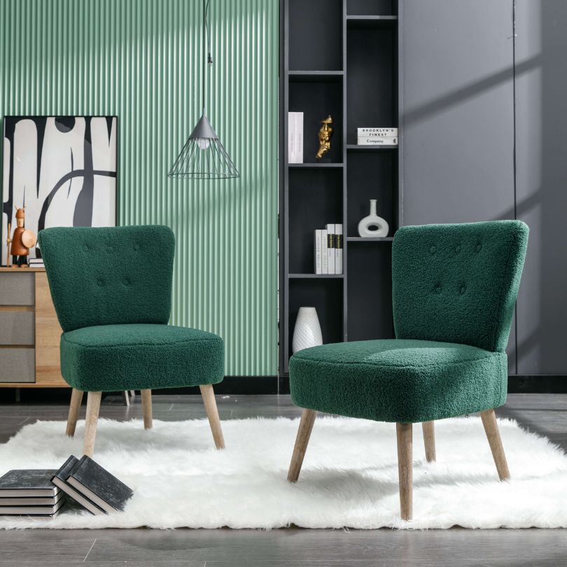 Elegant green teddy fabric accent chair from the side, highlighting tufted buttons and wooden legs.