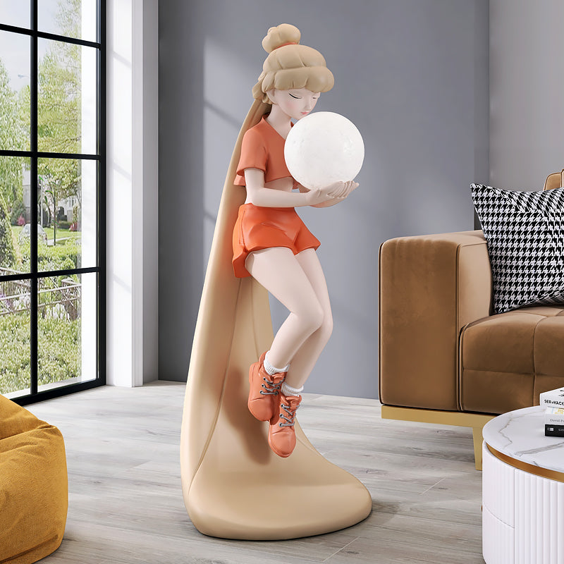 Trendy long-haired girl sculpture floor lamp in a cozy living room setting, showcasing its warm glow.