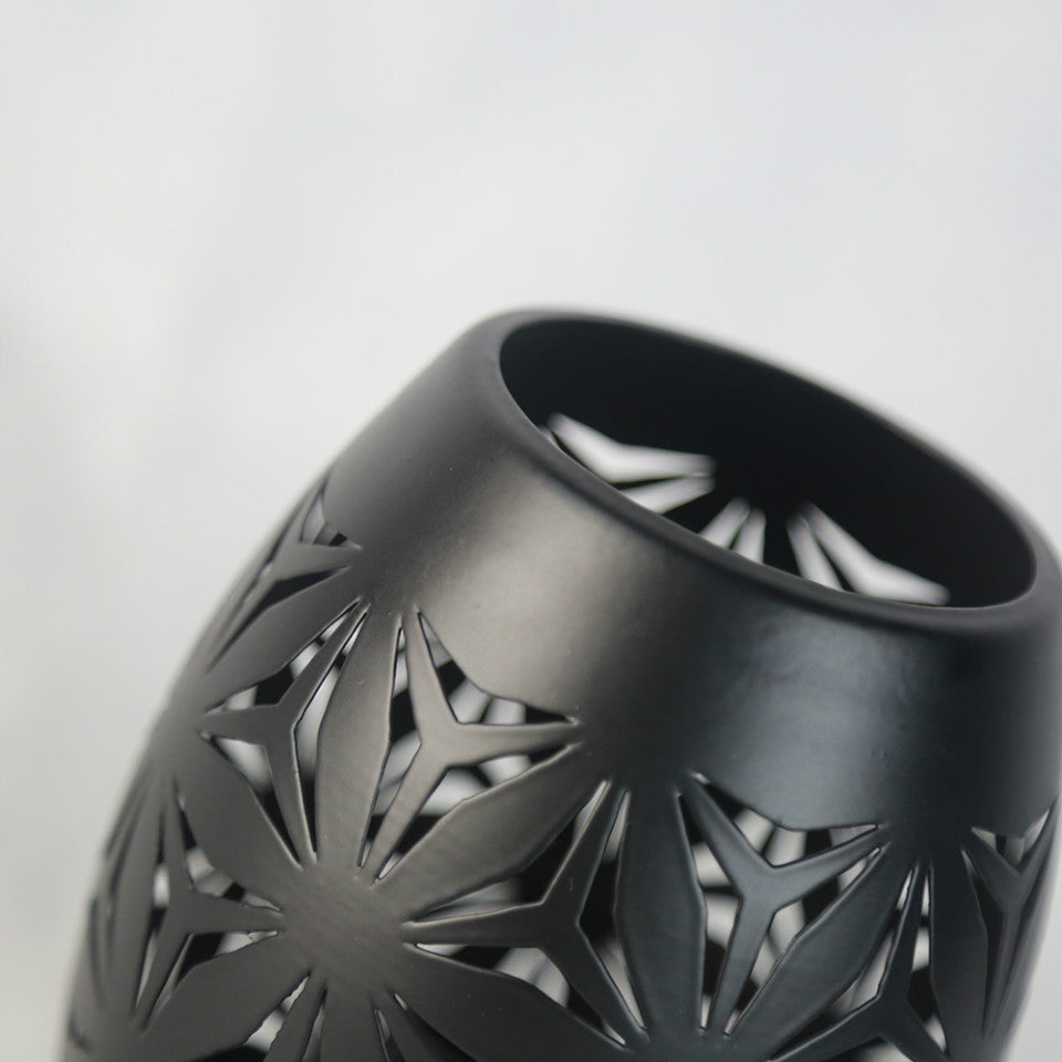 Elegant black LED decorative table lamp on a stylish coffee table, showcasing its modern design.