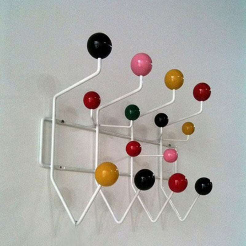 Colorful coat rack showcasing vibrant hooks in a bright entryway.