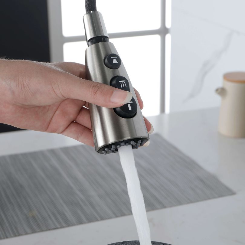 Close-up of the single handle mechanism of the high arc kitchen faucet with a brushed nickel finish.
