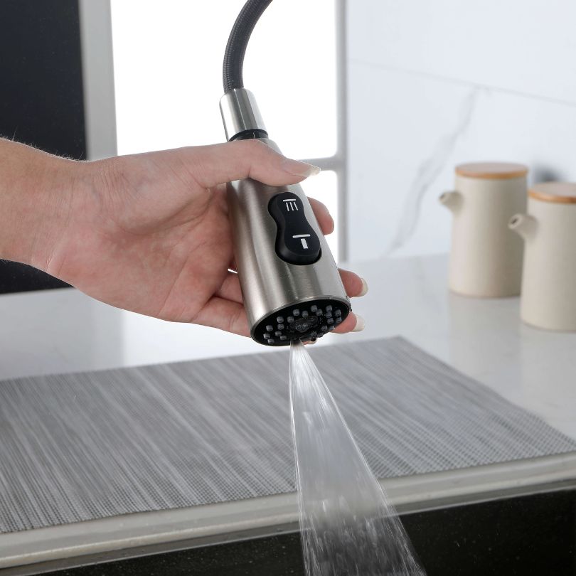 Brushed nickel high arc kitchen faucet showcasing its modern design and pull-down sprayer.