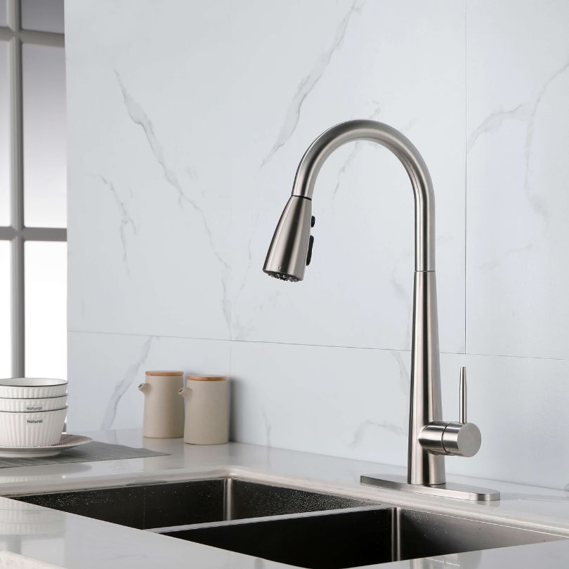 Brushed nickel high arc kitchen faucet showcasing its modern design and pull-down sprayer.