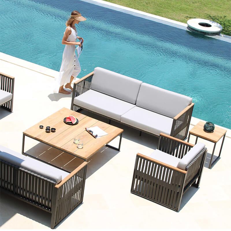 Close-up of the Horizon Outdoor Sofa showcasing the durable woven fibers and teak arms.