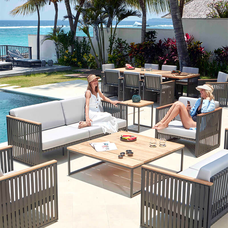 The Horizon Modern Outdoor Sofa Set arranged for relaxation, featuring deep cushions in a sunny outdoor environment.