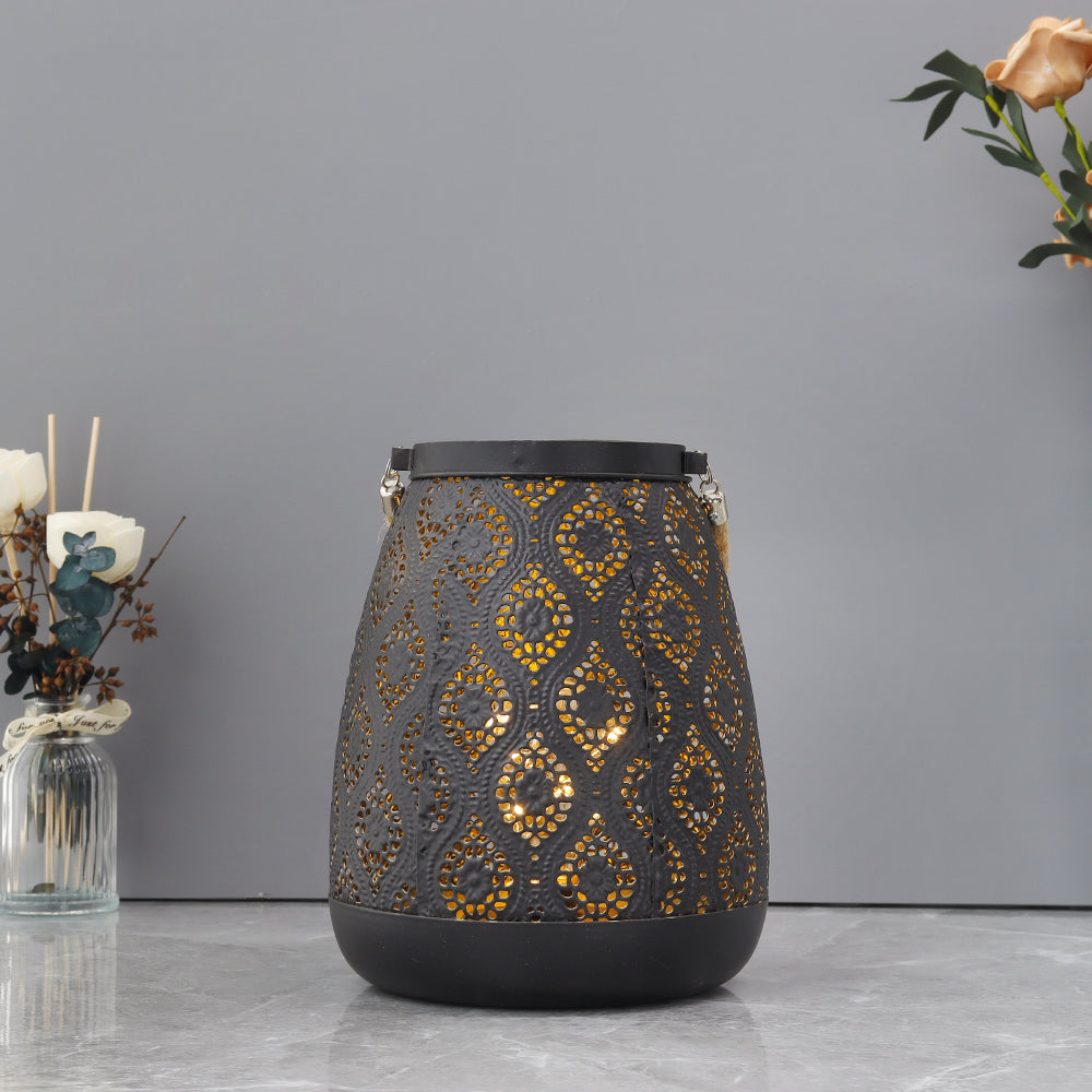 Side view of the vintage black metal table lamp showcasing its intricate design and warm light.