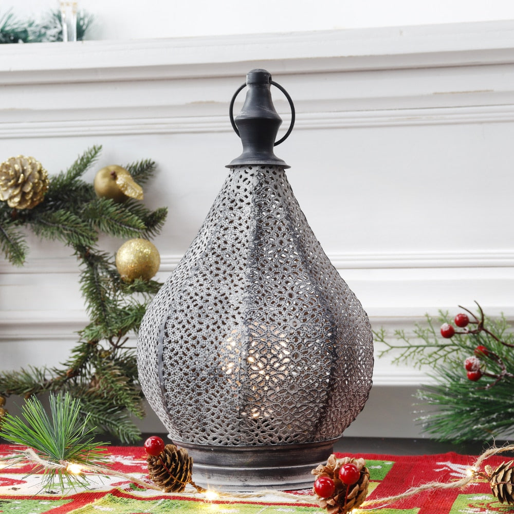 Black metal Moroccan lamp on a side table casting beautiful patterns on the wall.