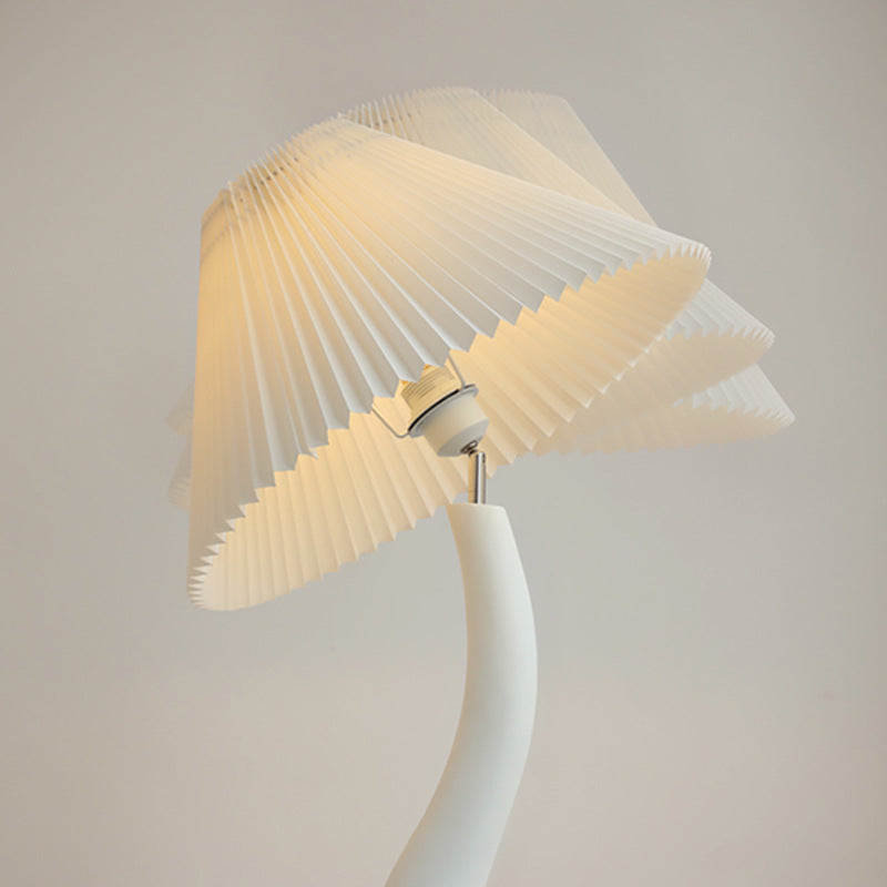 Elegant Curved Mushroom Resin Floor Lamp with warm light in a cozy living room setting.