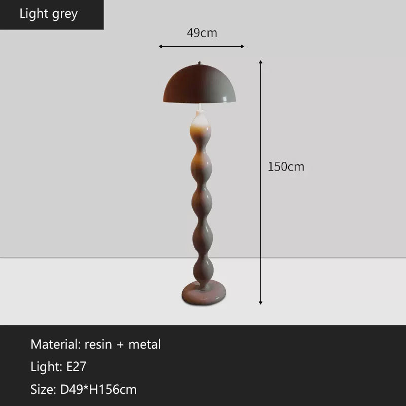 Contemporary minimalist LED mushroom floor lamp in a cozy living room corner.