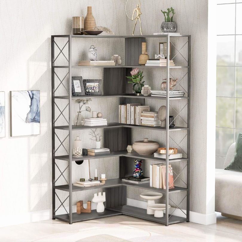 Stylish silver grey industrial corner bookcase with books and decor displayed on shelves.