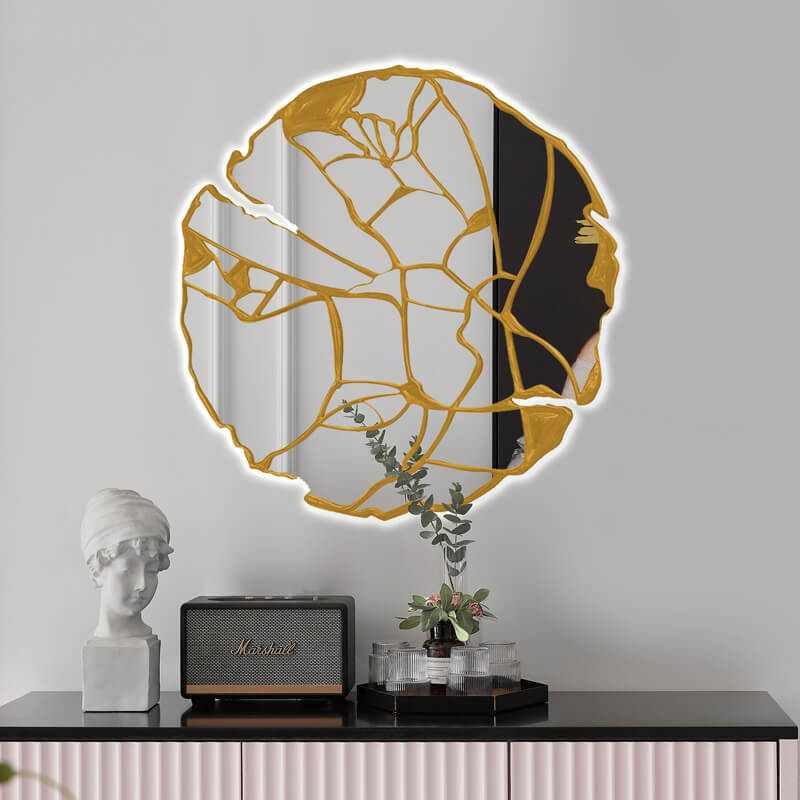 Stylish round wall mirror displayed above a bed, enhancing the rooms luxury appeal.
