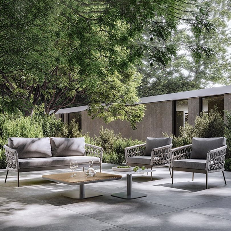 Italian-inspired modular woven rope sofa set in a garden setting.
