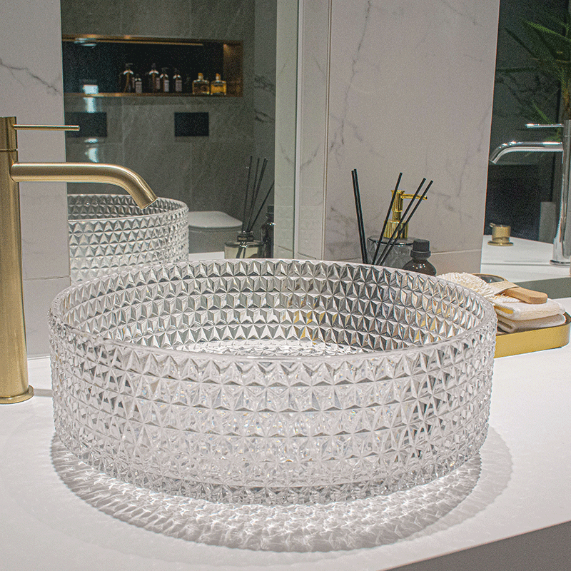 Close-up of the crystal glass vessel sink, emphasizing the fine craftsmanship and luxurious appeal.