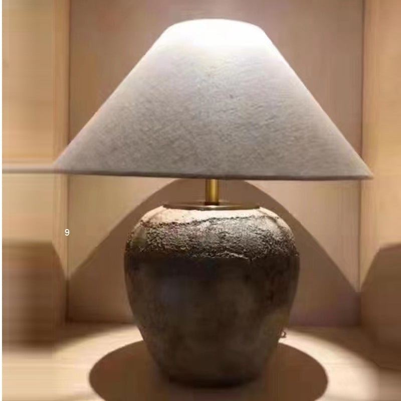 Elegant retro ceramic table lamp on a bedside table, showcasing its stylish design and warm glow.