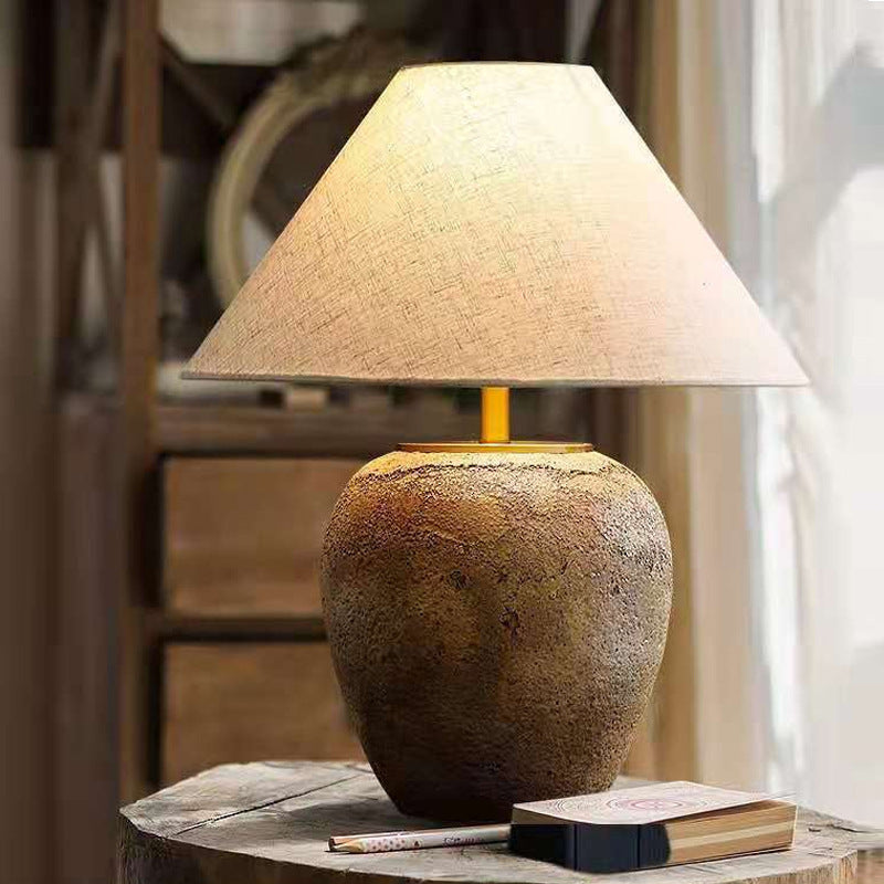 Modern LED table lamp for living room decor, highlighting the ceramic base and fabric shade.
