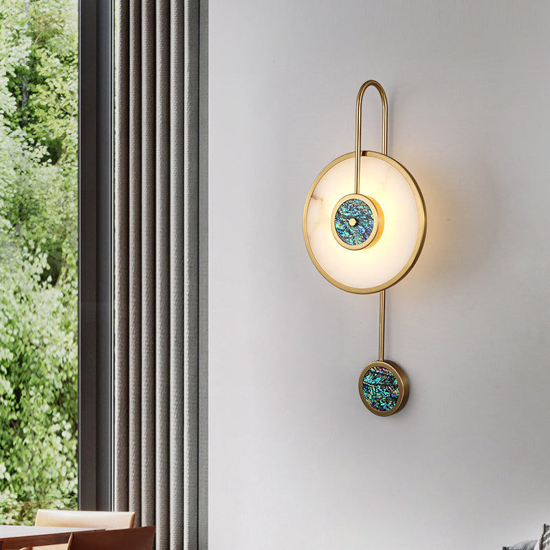 Elegant gold copper wall sconce illuminating a stylish hallway, adding warmth and ambiance.