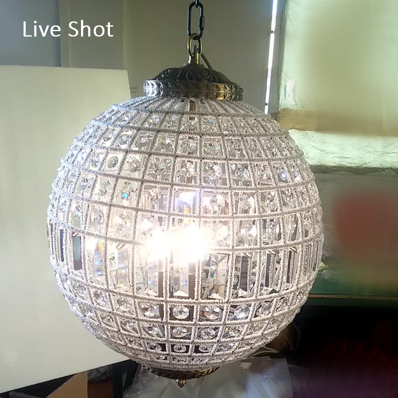Unique crystal pendant light illuminating a chic kitchen island.