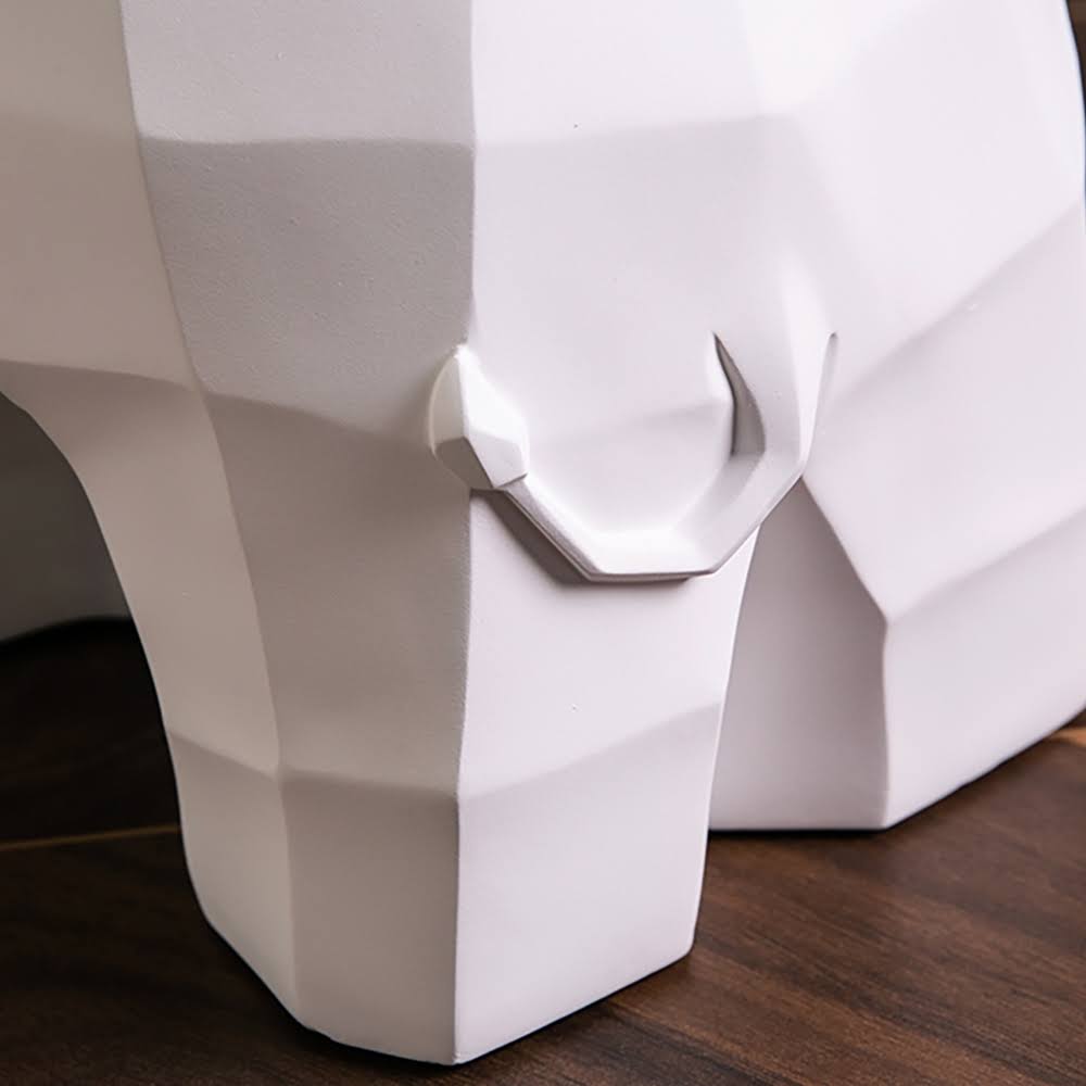 Side view of large resin elephant sculpture in a stylish living room.