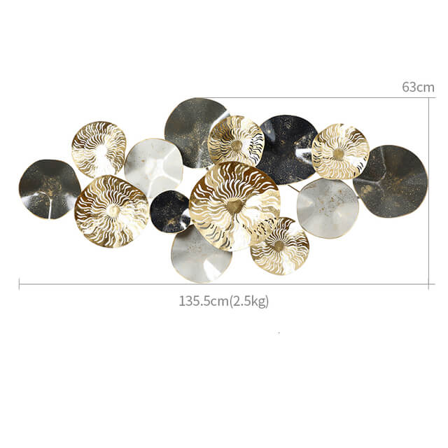 Close-up of gold wall decor accent highlighting its intricate texture against a neutral wall.